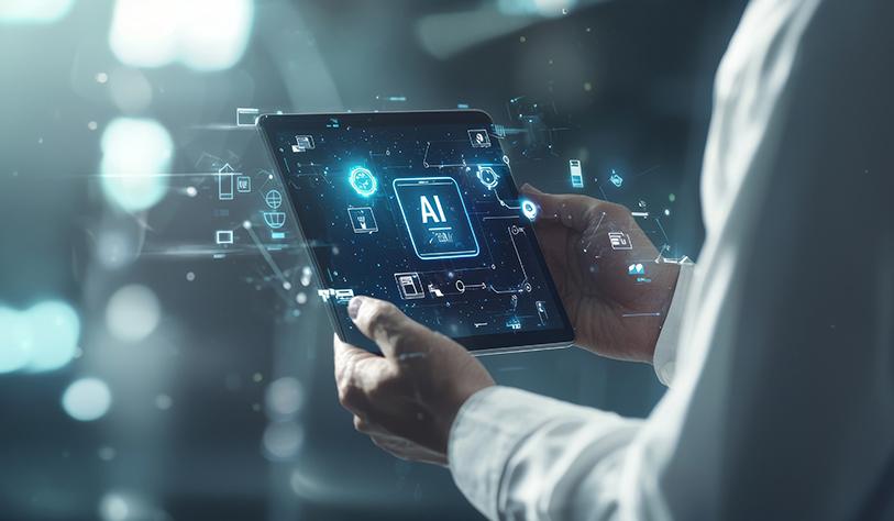 A person in a white business shirt holds a tablet displaying the letters 'AI'. Glowing technology-themed icons surround the tablet, symbolising artificial intelligence and innovation.