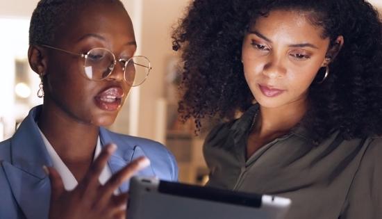 Individuals looking at tablet